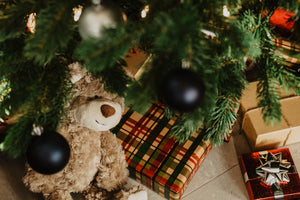 christmas tree with gifts and childs teddy